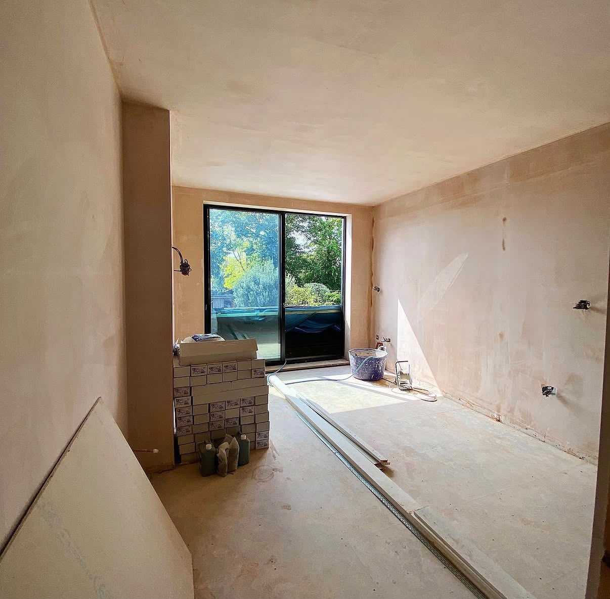 Open room fully plastered with sliding door and garden view